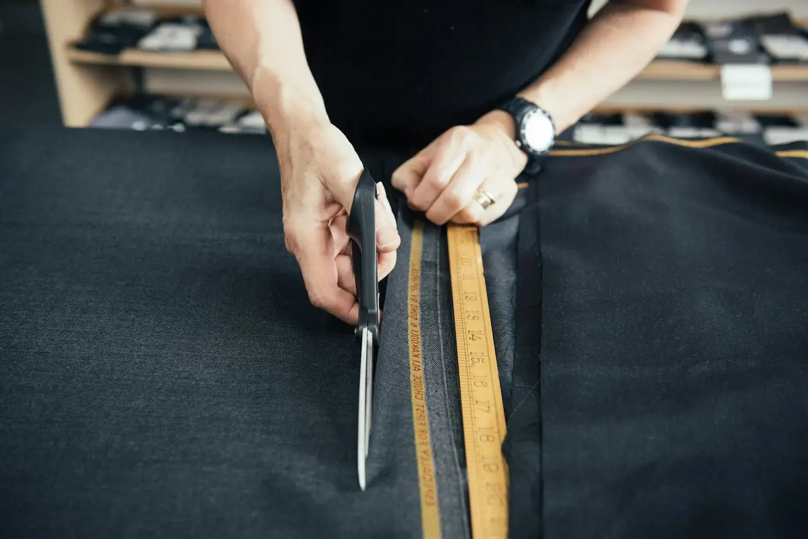 Hands cutting fabric with scissors